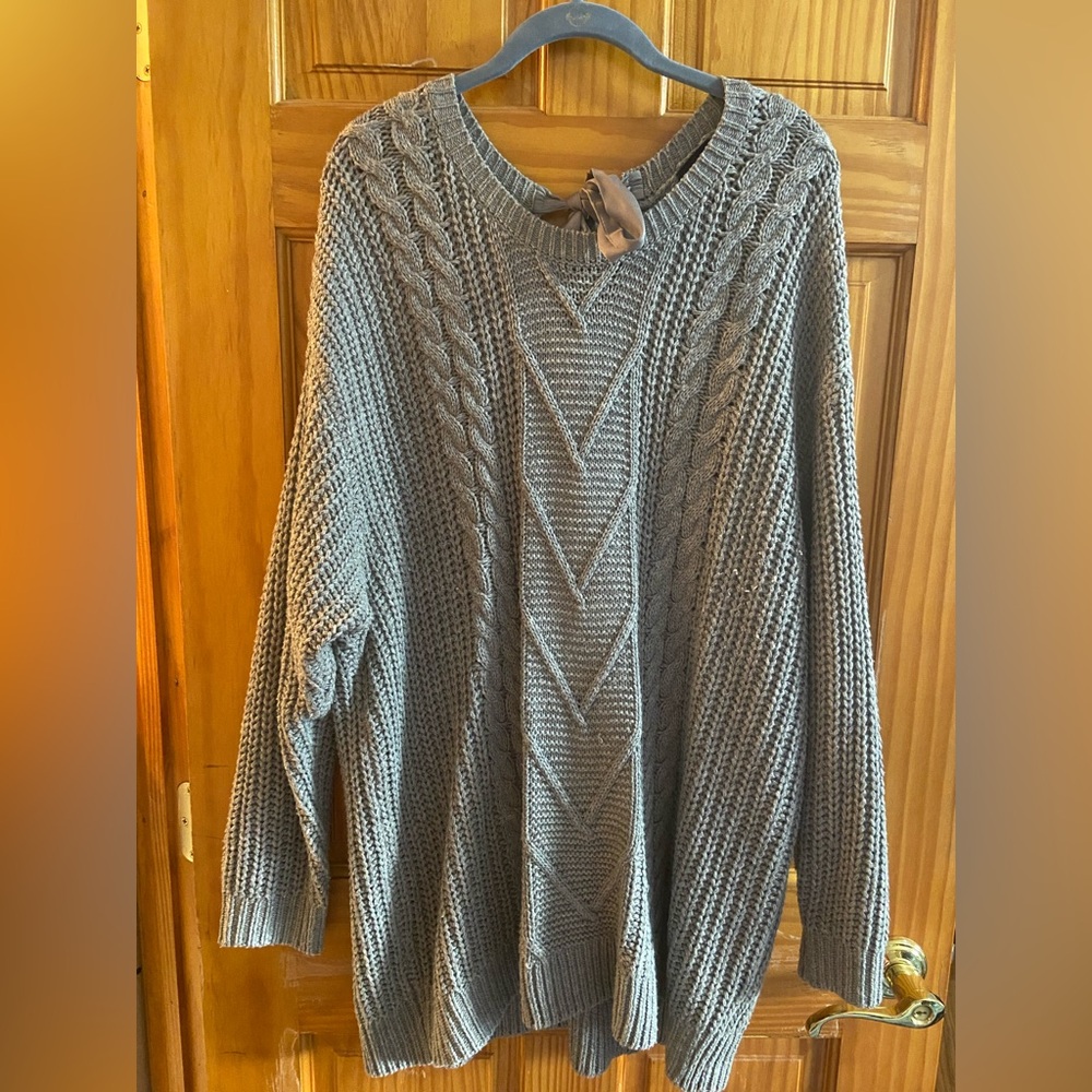 Gray sweater with “bow tie” in back.